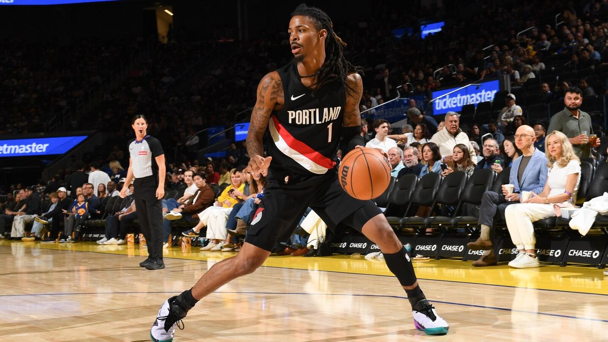 Ja Morant dribbles with his left hand in a black Portland Trail Blazers No. 1 jersey.
