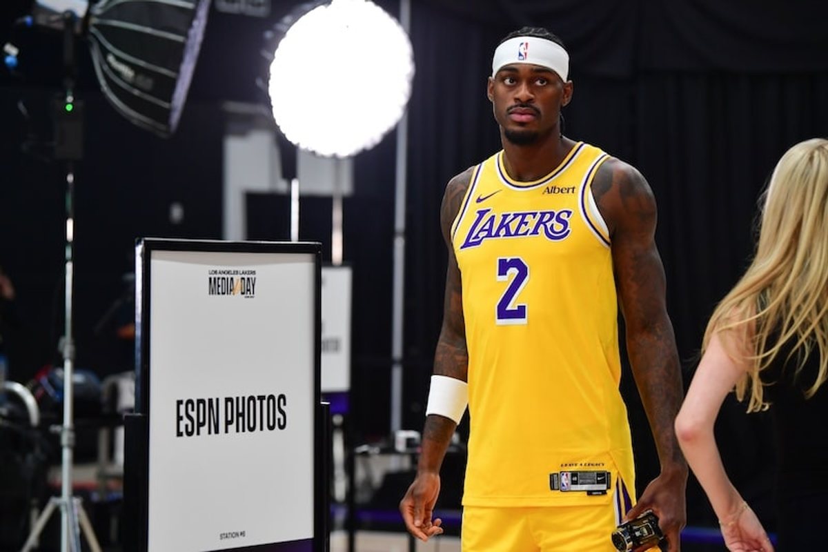 Jarred Vanderbilt poses in a gold Lakers No. 2 jersey at media day.